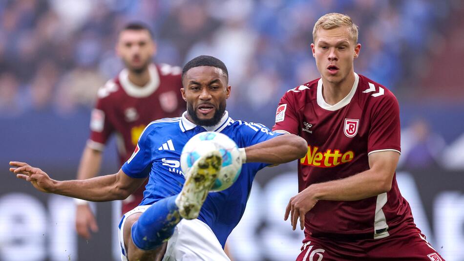 Schalkes Moussa Sylla im Zweikampf mit dem Regensburger Louis Breunig.