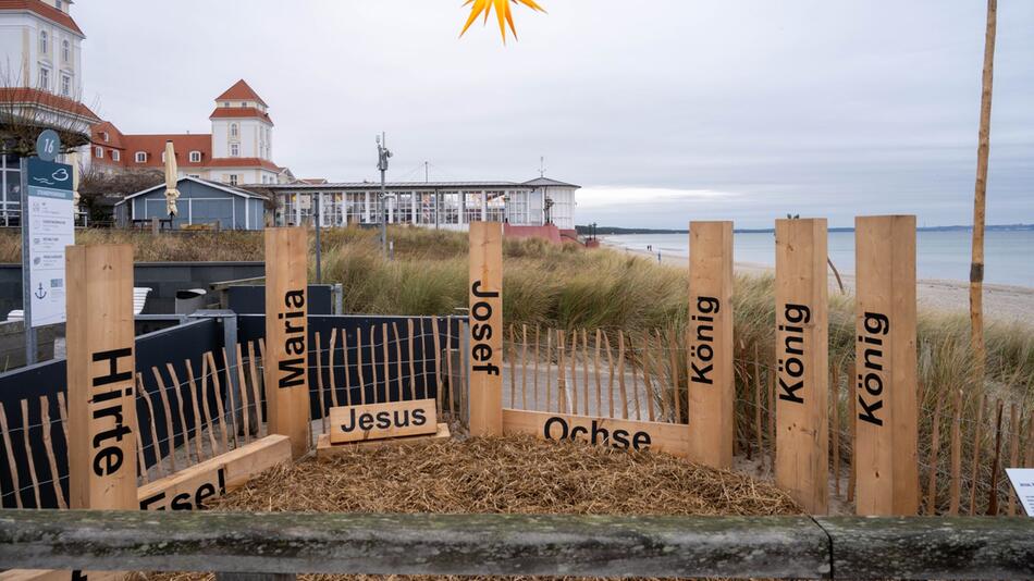 Weihnachtskrippe aus Holzpfosten am Strand