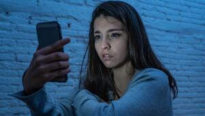 Eine junge Frau blickt auf ihr Smartphone