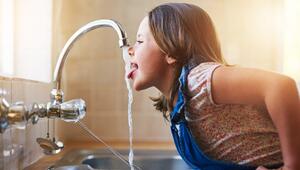 Foto eines Kindes, das aus der Wasserleitung trinkt
