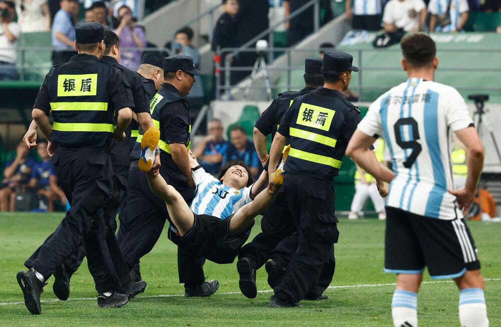Sicherheitskräfte in Peking entfernen am 15. Juni 2023 einen Fan Lionel Messis vom Spielfeld