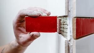Mann ersetzt eine Wandfliese