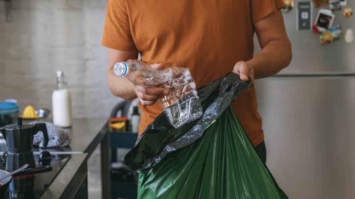 Mann sammelt Müll für einen plastikfreien Haushalt.